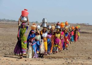 Indian women carry drinking water in the Medak district of Andhra Pradesh