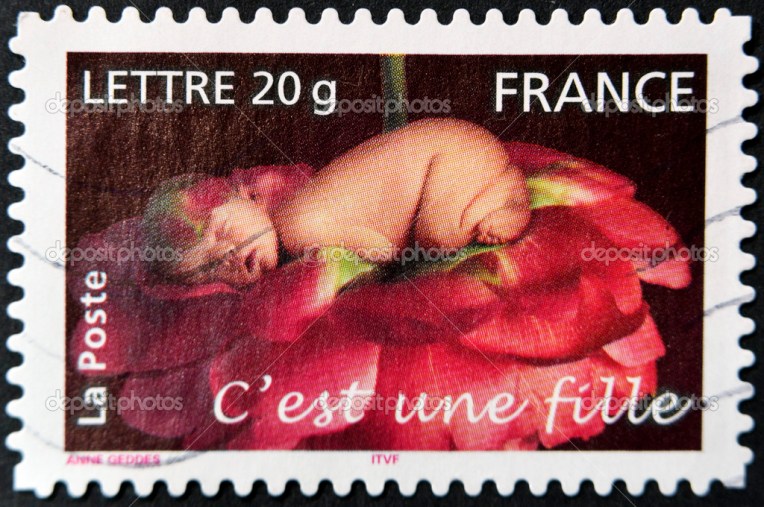 FRANCE - CIRCA 2005: A stamp printed in France shows sleeping baby in a rose, circa 2005